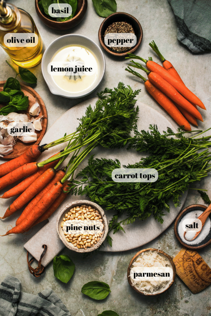 Ingredients for carrot top pesto labeled on counter.