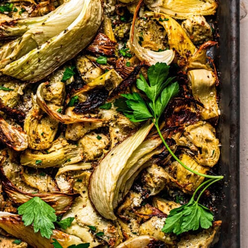 Overhead close up of roasted fennel and artichoke hearts on baking sheet.