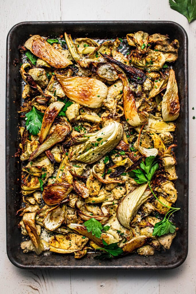 Overhead shot of roasted fennel and artichoke hearts on baking sheet.