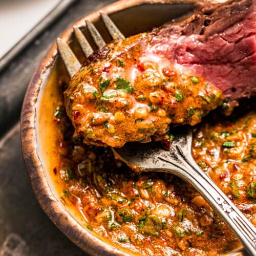 Overhead close up of piece of steak dipped into cowboy butter.