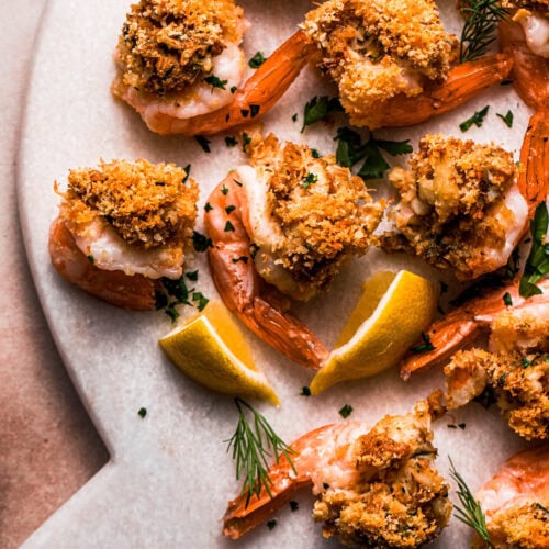 Close up of crab stuffed shrimp on serving plate.