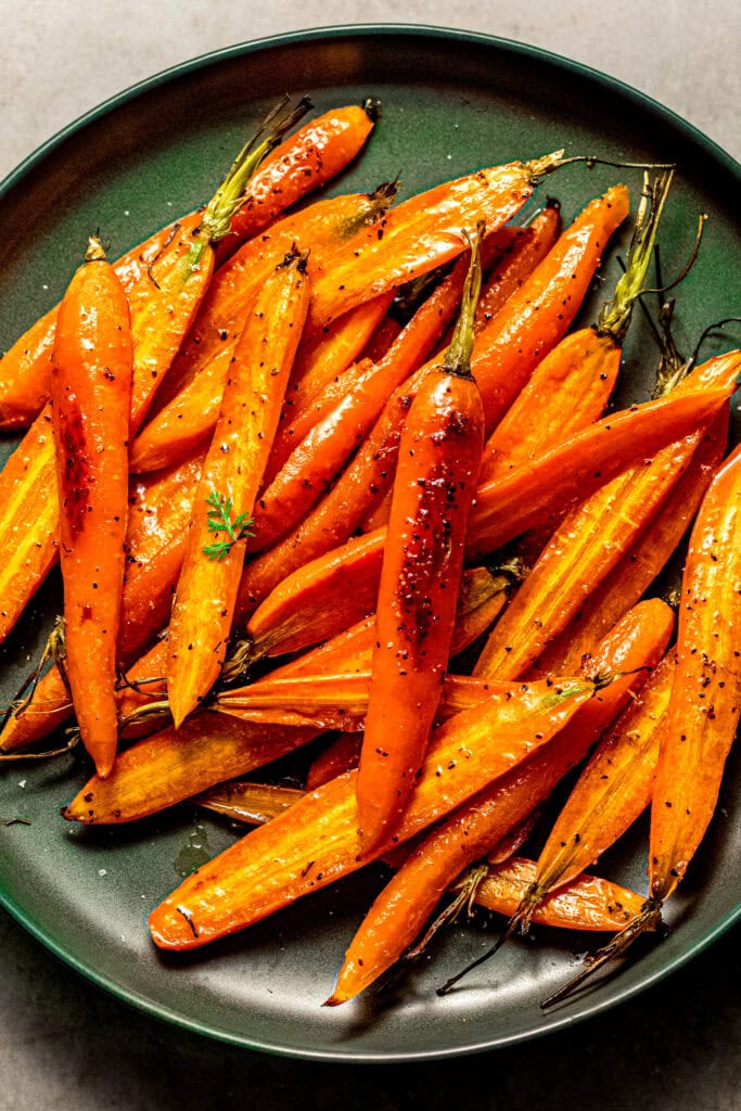Overhead close up of honey roasted carrots on serving plate.