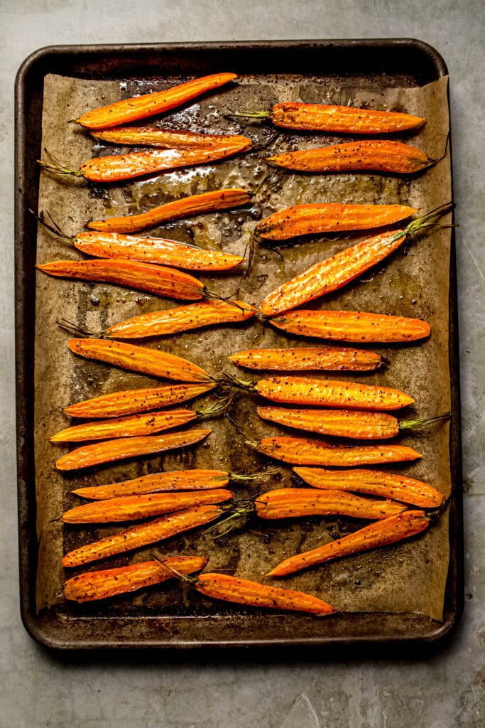 Finished roasted carrots on baking sheet.