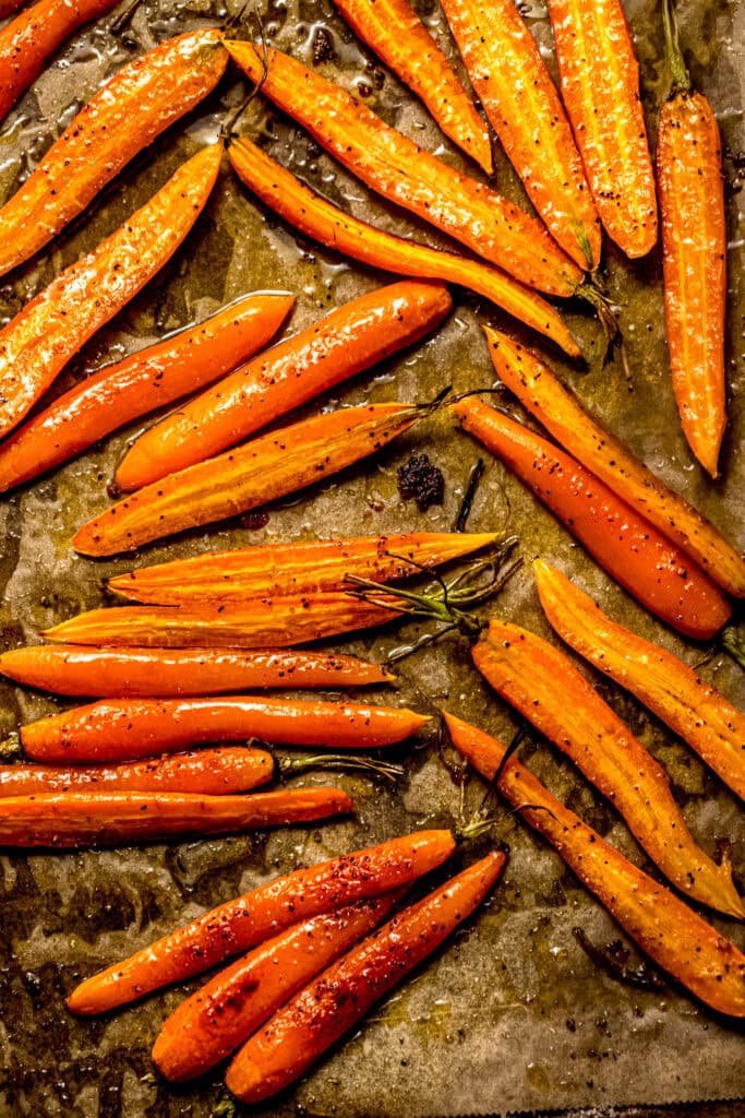 Close up of honey roasted carrots on baking sheet.
