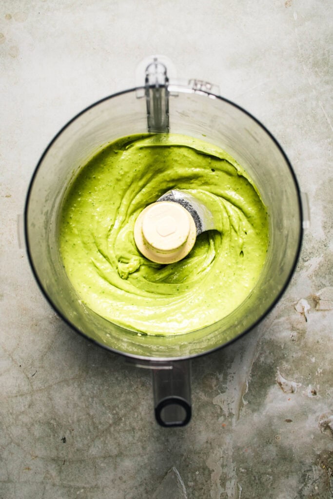 Finished creamy avocado pasta sauce in food processor bowl.