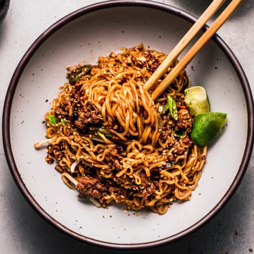 Finished ground beef ramen in bowl with chopsticks.