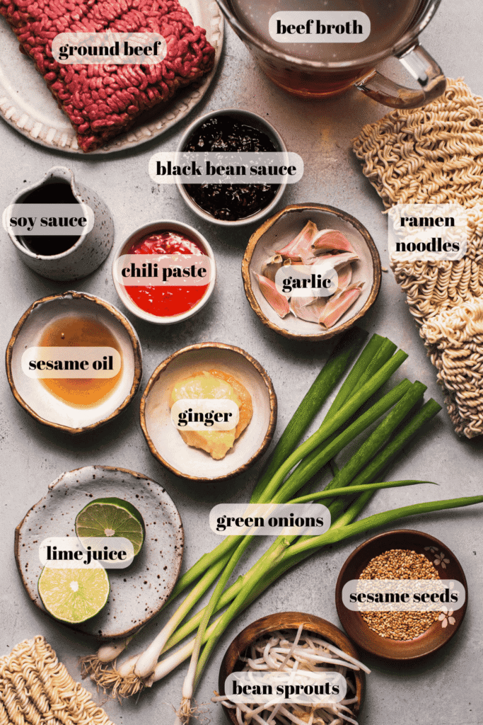 Ingredients for ground beef ramen labeled on counter.