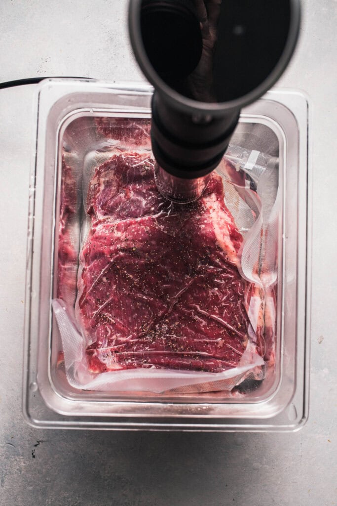 Flank steak in sous vide water bath.