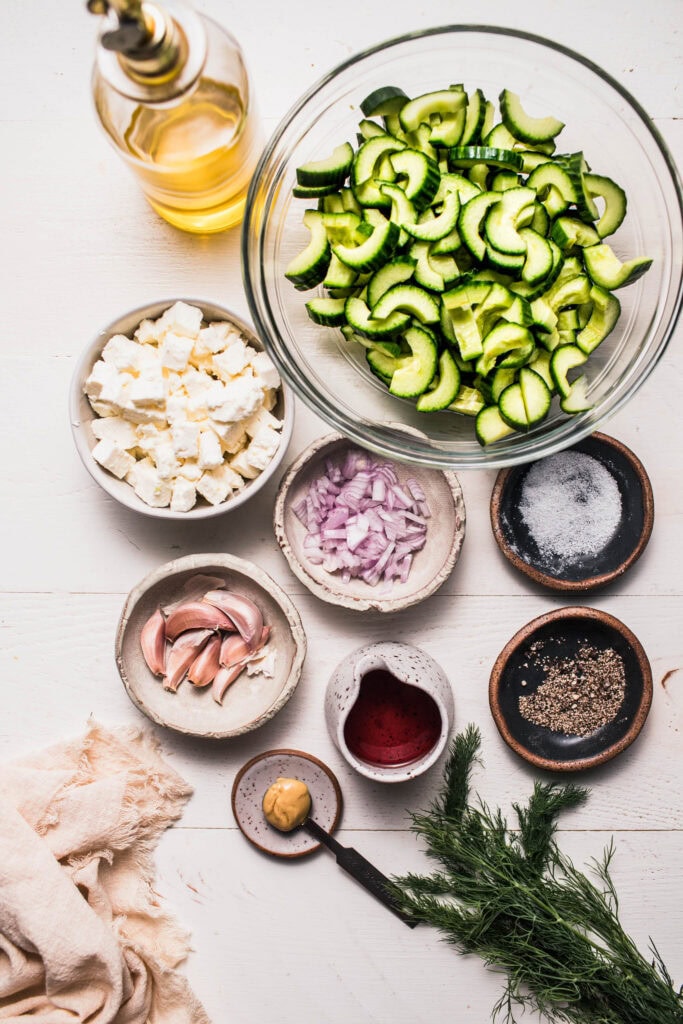 Ingredients for feta cucumber salad on counter.