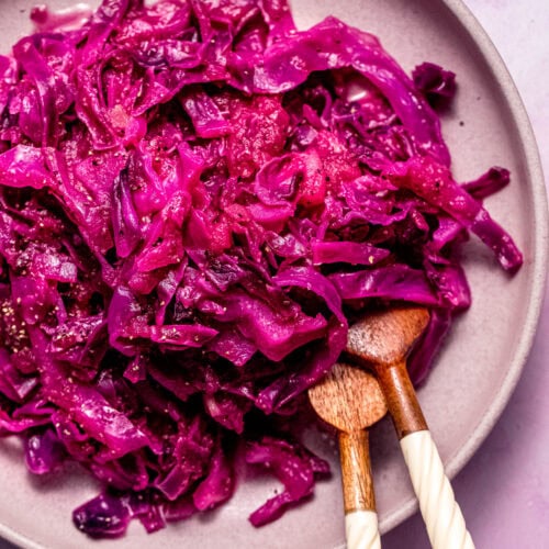 Finished braised red cabbage in pink serving bowl.