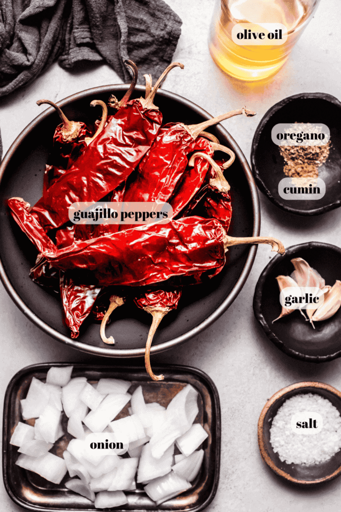 Ingredients for guajillo sauce labeled on counter.