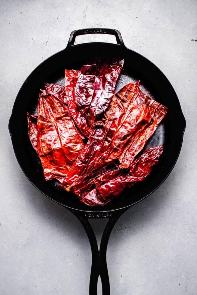 Peppers being toasted in skillet.