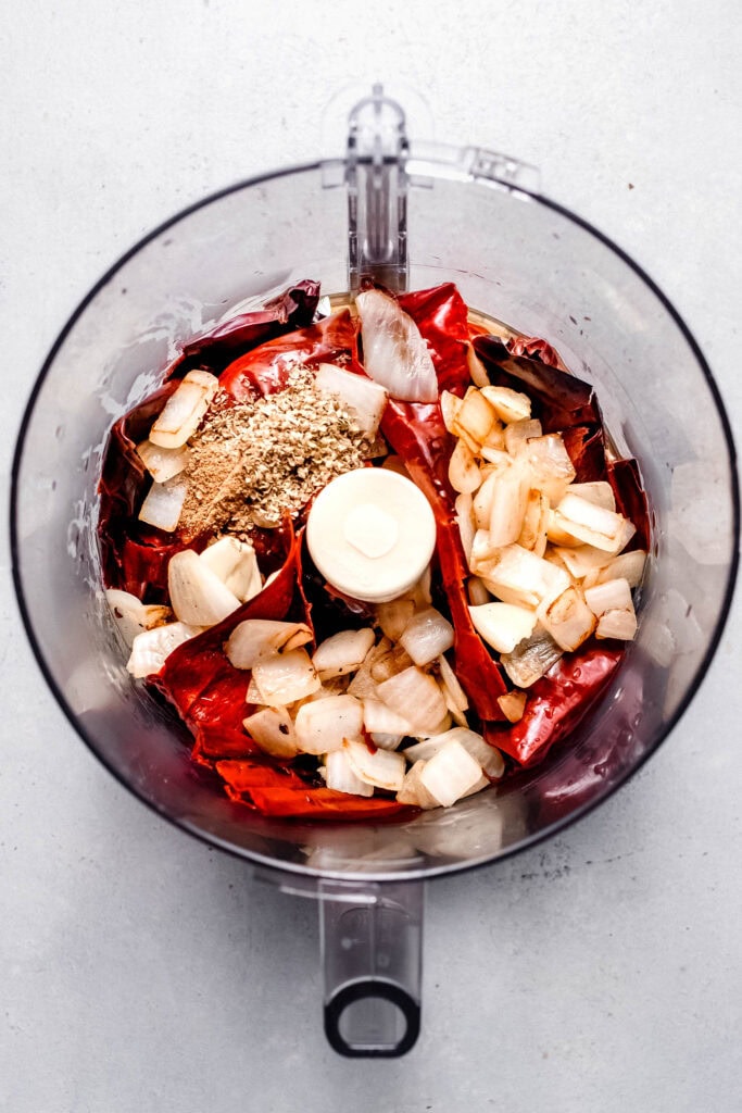 Ingredients for guajillo sauce in food processor.