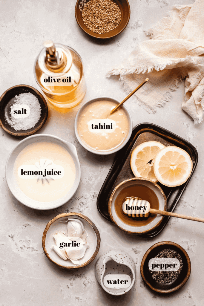 Ingredients for tahini dressing labeled on counter.
