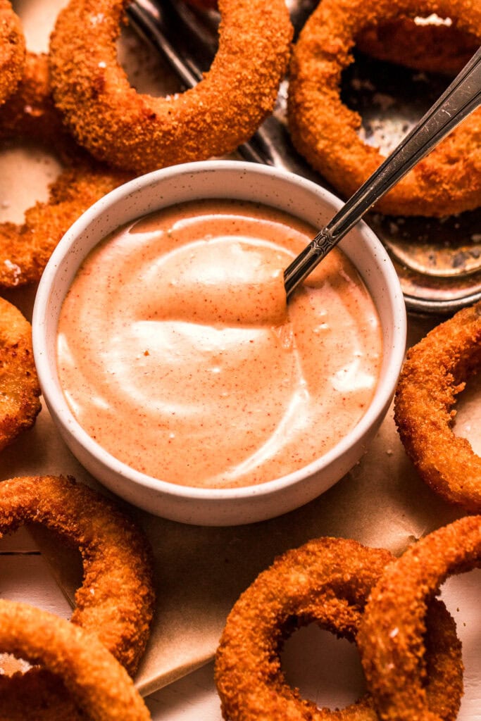 Onion ring sauce stirred together in bowl.