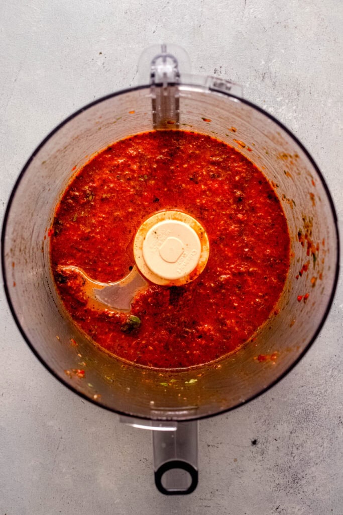 Finished Red chimichurri sauce ingredients in food processor bowl.