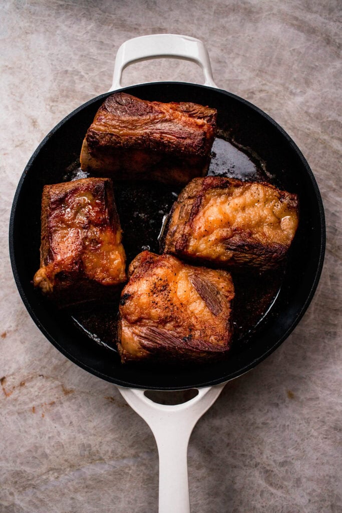 Short ribs browning in skillet.