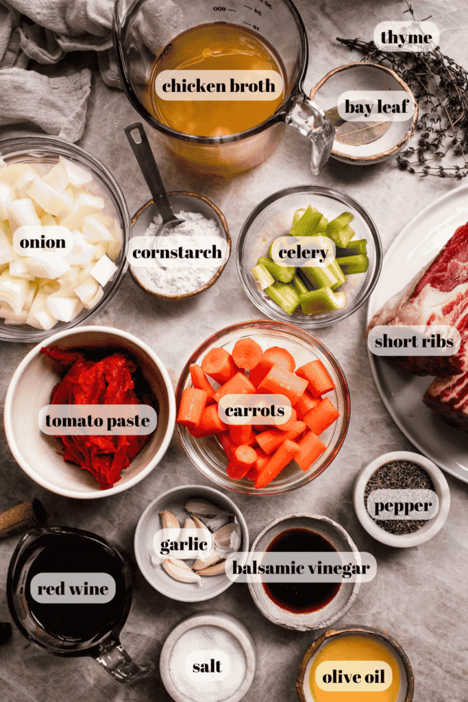 Ingredients for slow cooker short ribs labeled on counter.