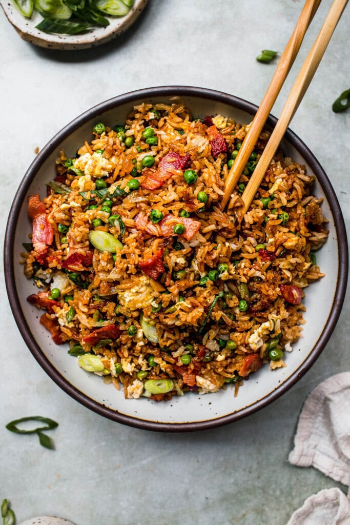 Hibachi fried rice in serving bowl with chopsticks.