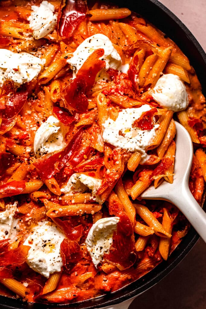 Overhead close up of spicy vodka rigatoni being scooped out of skillet.