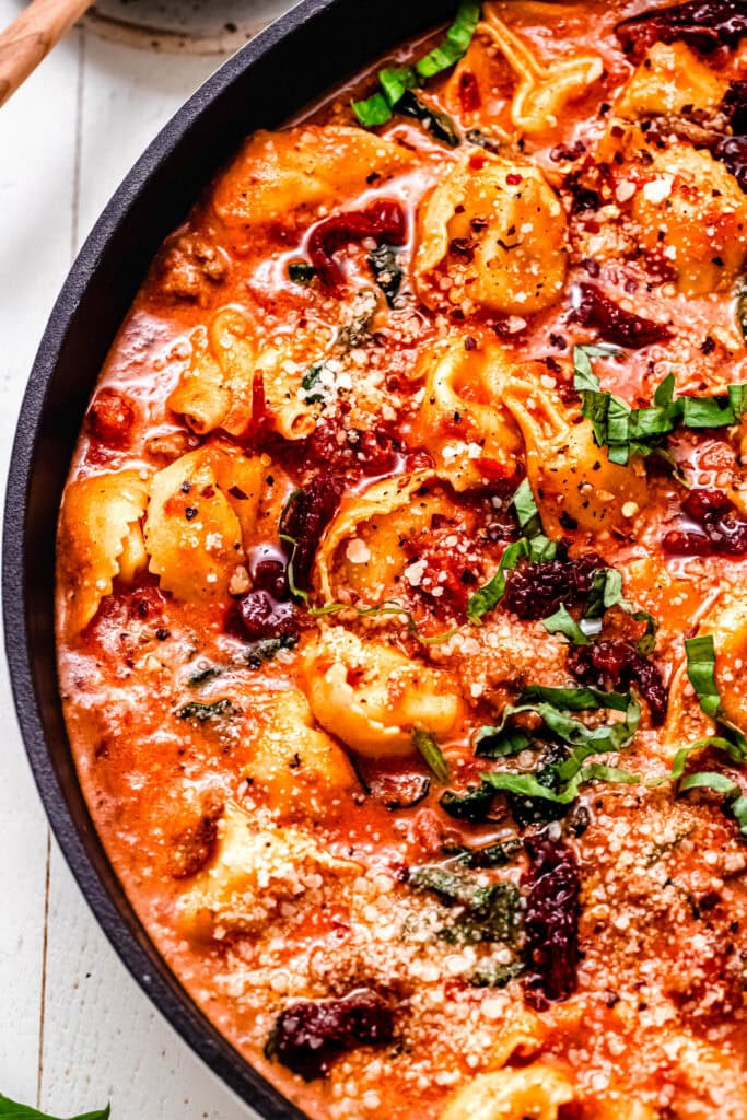 Prepared marry me tortellini in skillet with serving spoon.