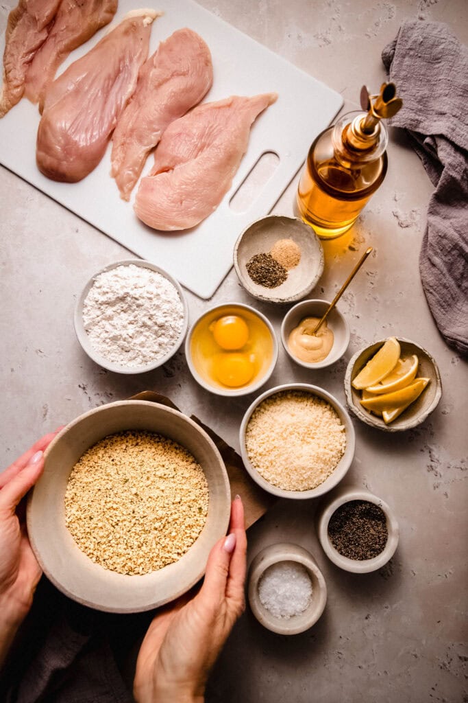 Ingredients for parmesan chicken cutlets on counter.