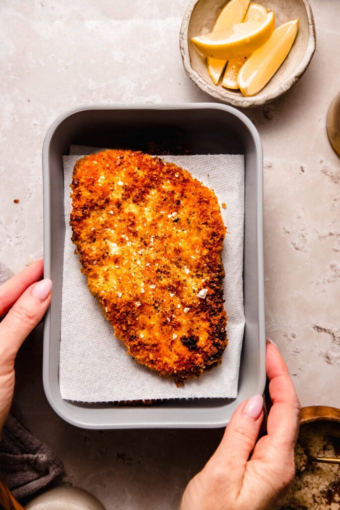 Crispy parmesan panko cutlet in food storage container.