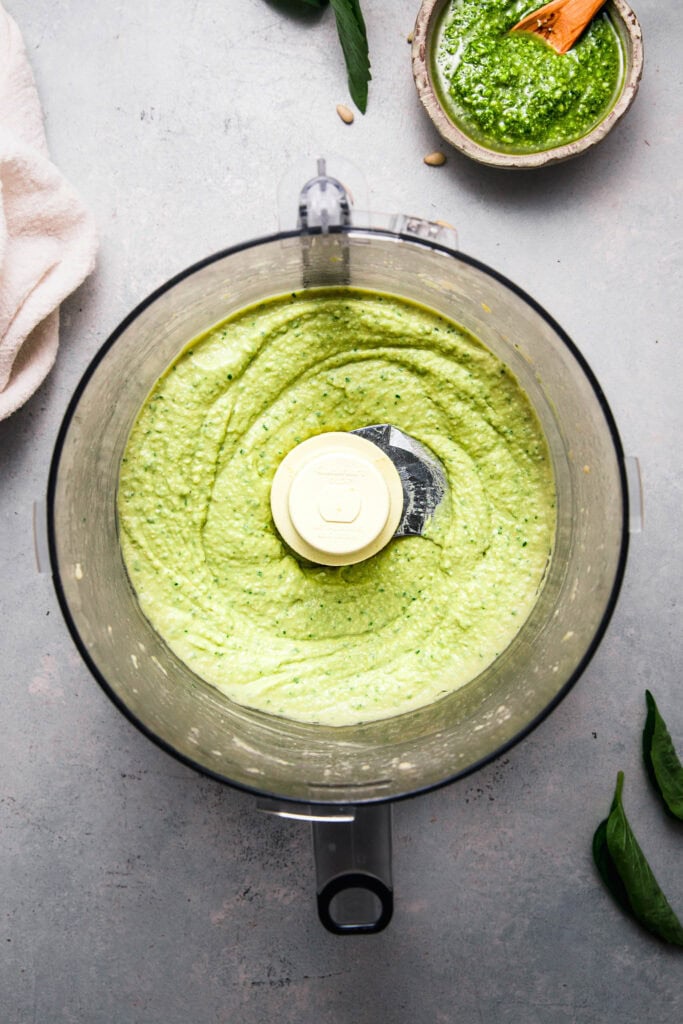 Finished pesto hummus in food processor bowl.