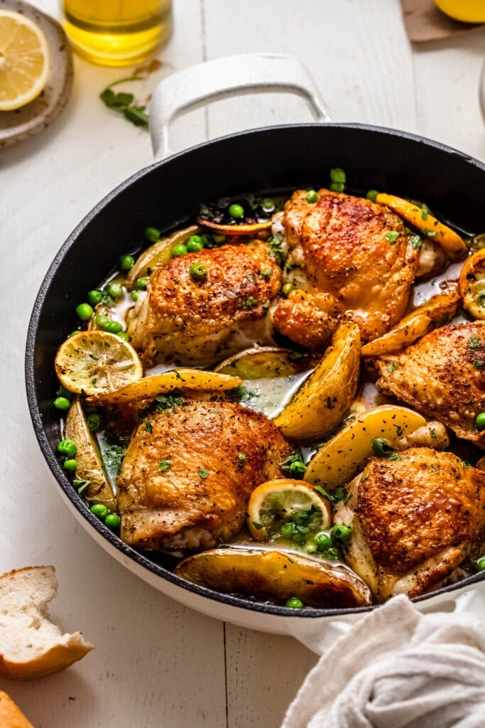 Side view of chicken vesuvio in skillet.