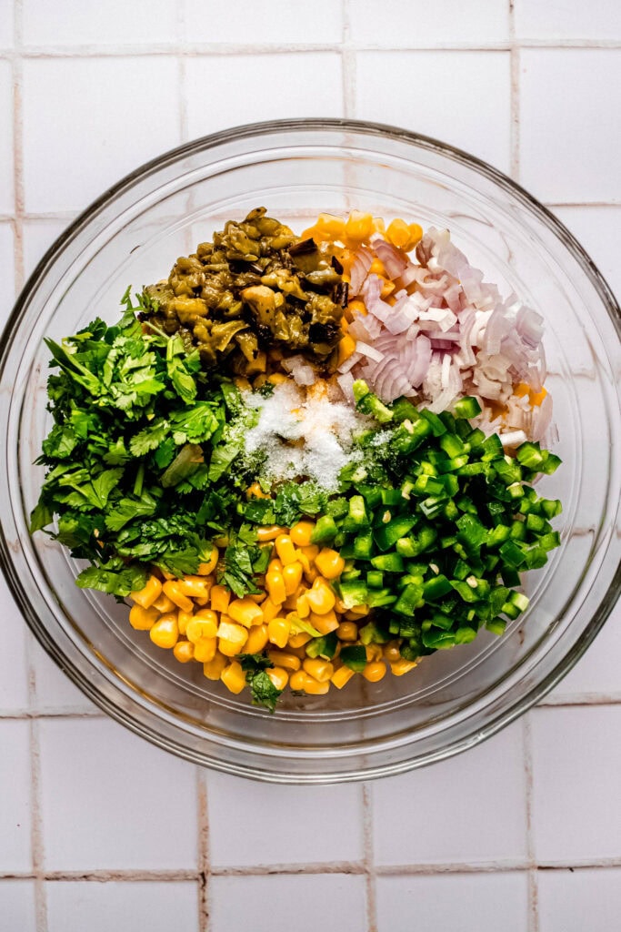 Ingredients for copycat chipotle corn salsa in bowl before mixing.