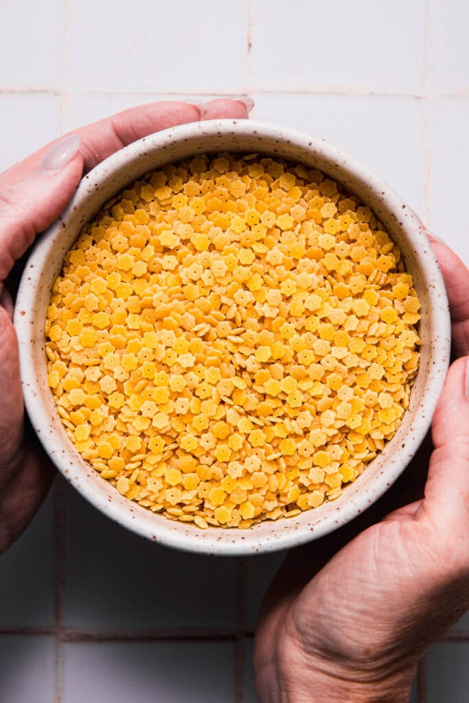 Hands holding bowl of pastina.