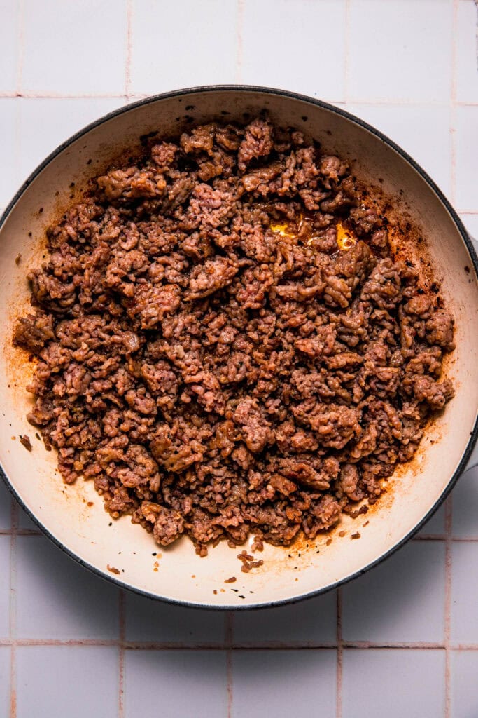 Browned italian sausage in skillet.
