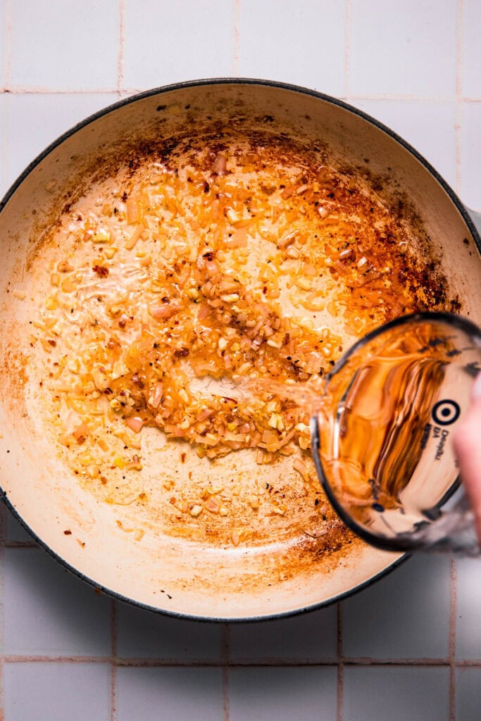 Vodka being added to skillet.