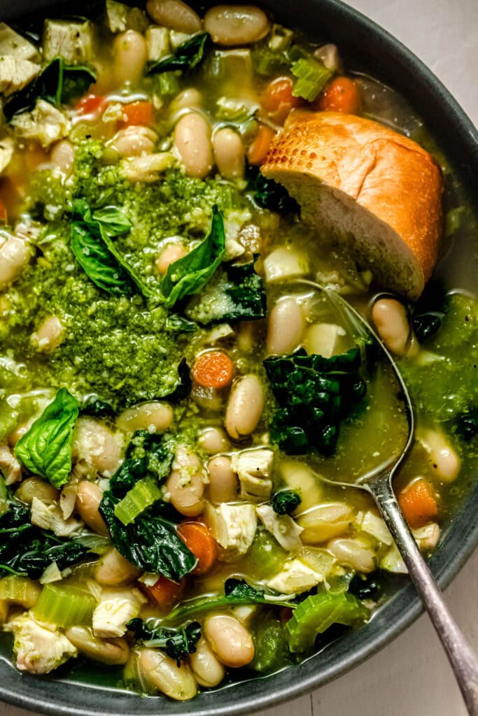 Overhead close up of bowl of pesto chicken soup.