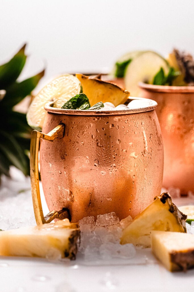 Side view of pineapple moscow mule in copper mug.