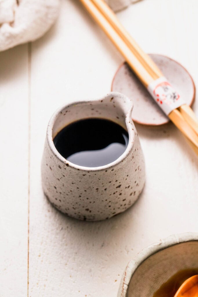 Sauce for fried rice in small pouring vessel.