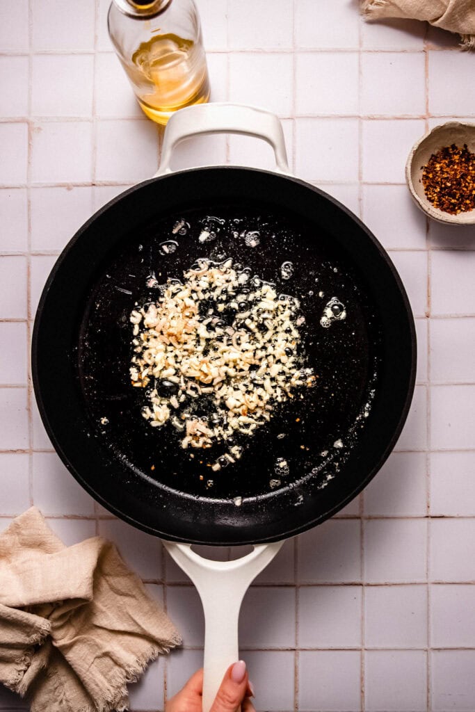 Garlic cooking in skillet.