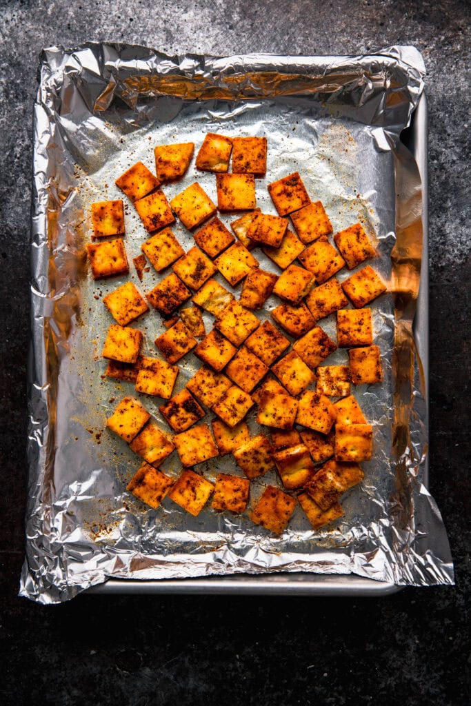 Naan croutons on baking sheet.