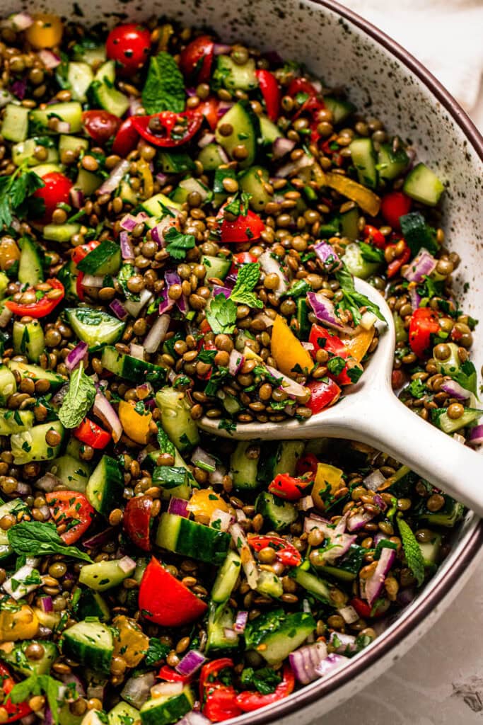 Overhead close up of lentil tabbouleh salad with serving spoon.