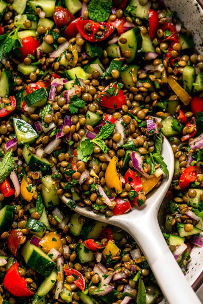 Overhead close up of lentil tabbouleh salad with serving spoon.