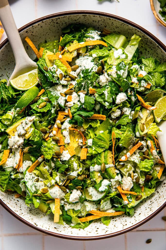 Overhead close up of Prepared Mexican caesar salad in large serving bowl.