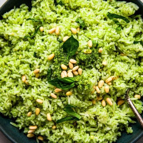 Overhead close up of green pesto rice in serving bowl.