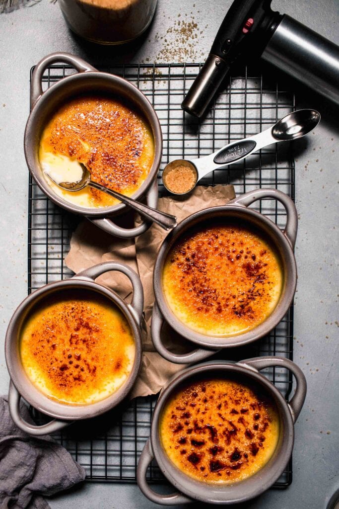 Four creme brulees on cooling rack