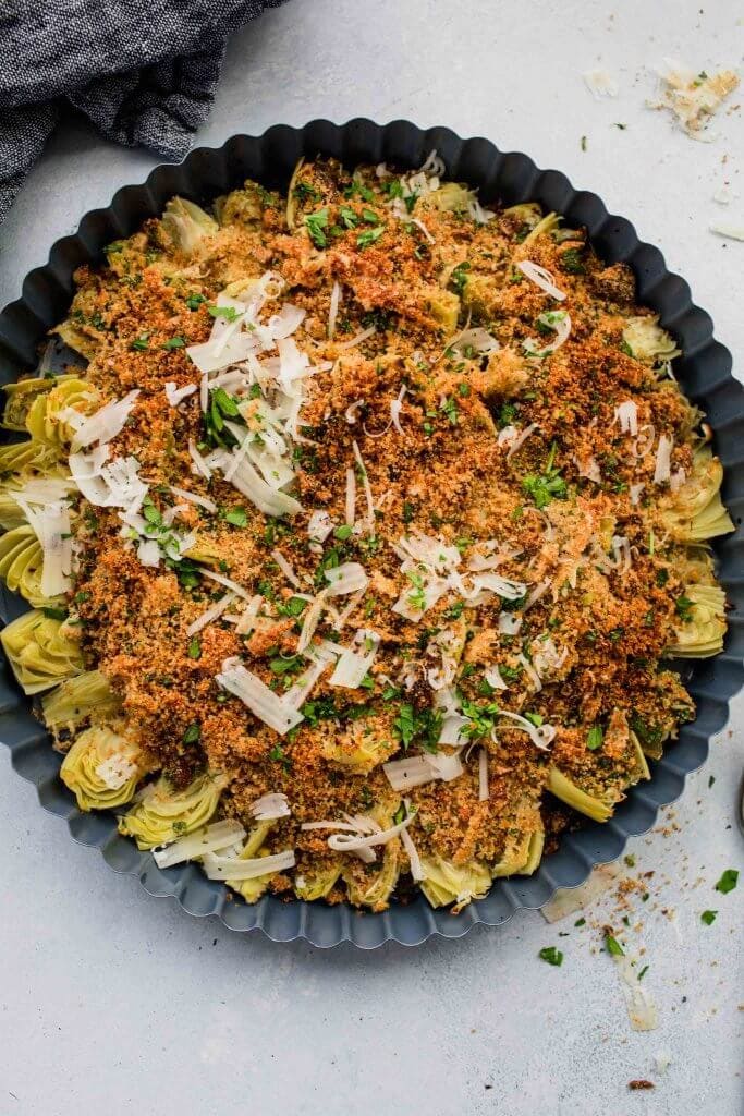 Baked artichoke hearts in baking dish after cooking.