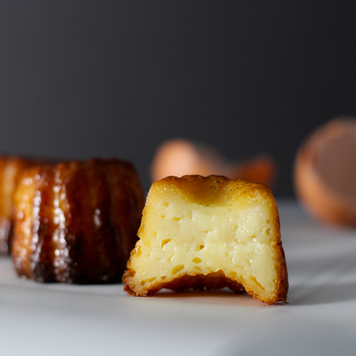 These Canelés or (Cannelés) de Bordeaux are a delicious little treat similar to a portable crème brulee. This version bakes them in silicone molds rather than the traditional copper variety. | platingsandpairings.com