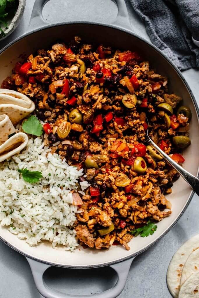 Picadillo in large saute pan with rice. 