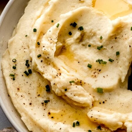 Swirled miso mashed potatoes in bowl sprinkled with chives.