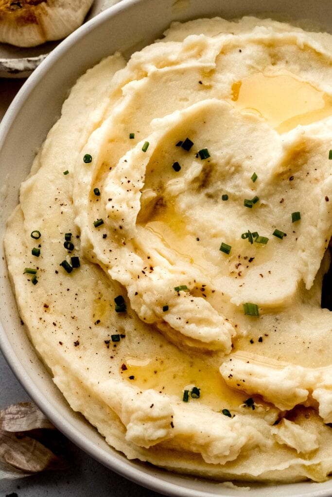 Swirled miso mashed potatoes in bowl sprinkled with chives.