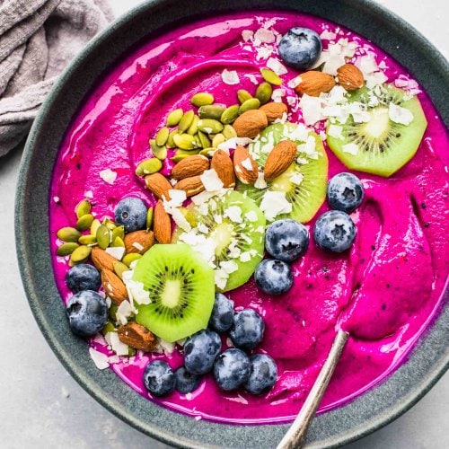 Dragon Fruit Smoothie Bowl topped with blueberries, coconut, almonds, kiwi and pumpkin seeds.