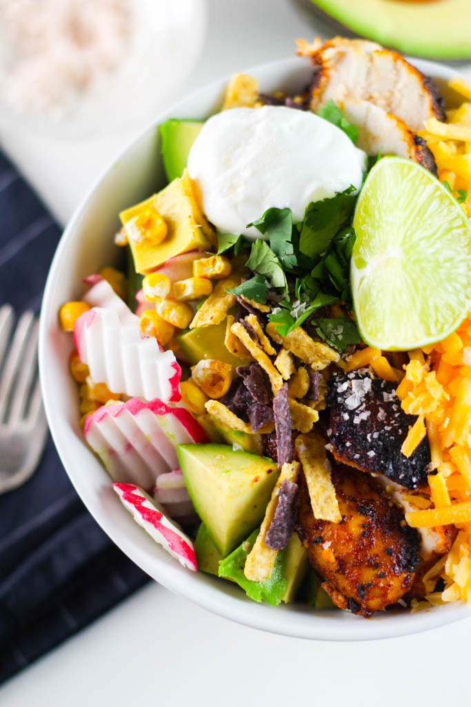 This Chipotle Chicken Salad features five superfoods and is fully loaded with spicy chicken, ditalini pasta, cheese, avocado, lime, cilantro, sour cream, and a zesty chipotle dressing | platingsandpairings.com